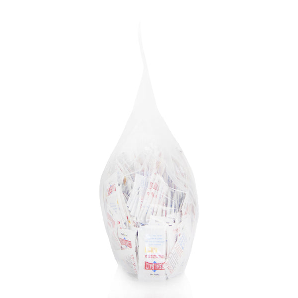 A clear bag holds numerous single-serving packets of Real Salt. 
