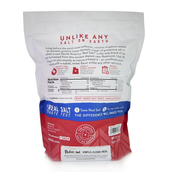 Back view of a Redmond Real Salt bag, showcasing the brand's commitment to natural, unrefined sea salt sourced from a single location in Utah. The bag highlights the salt's unique flavor profile, nutritional information, and endorsements from culinary experts. 
