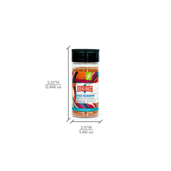 A jar of Real Salt Taco Seasoning sits against a white background with dimension markings indicating the height and width of the container. 
