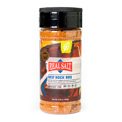 A jar of Real Salt Red Rock BBQ rub sits against a white background, showcasing its vibrant label and keto-friendly ingredients. 
