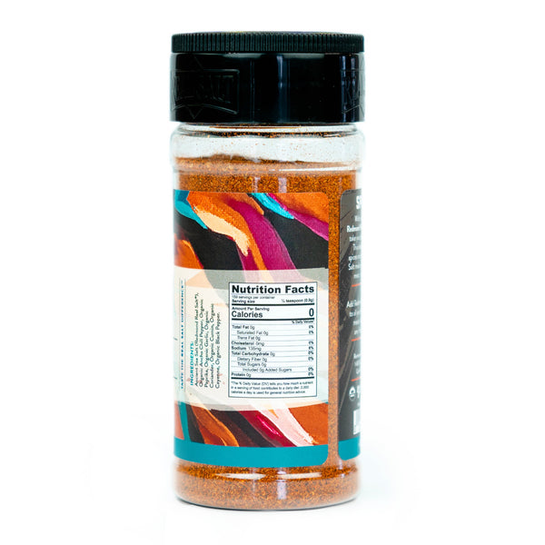 Clear glass jar filled with a vibrant red blend of Real Salt Spicy Seasoning. 
