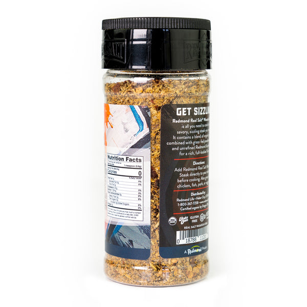 Clear glass jar of Redmond Real Salt Wasatch Steak Seasoning showcasing the product label and ingredients. 
