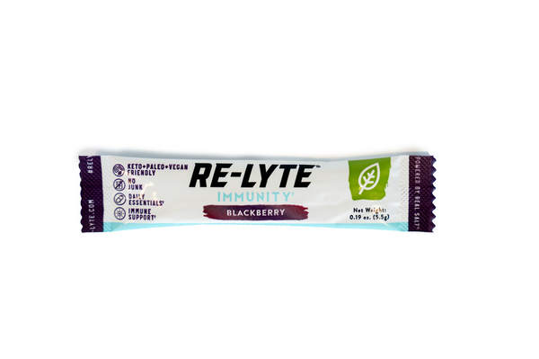A single-serving packet of Re-Lyte Immunity in Blackberry flavor sits against a white background. 
