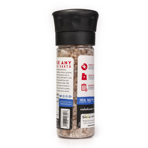 Clear grinder filled with coarse Redmond Real Salt and a black lid.