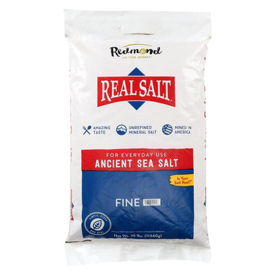 A 25-pound bag of Redmond Real Salt Ancient Sea Salt stands upright against a white background. 
